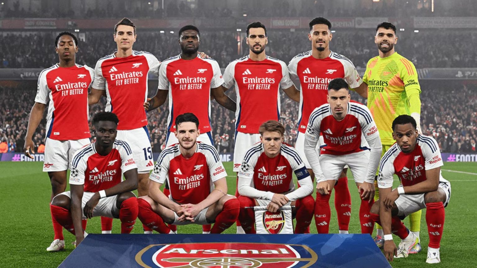 Arsenal players in red and white home kit